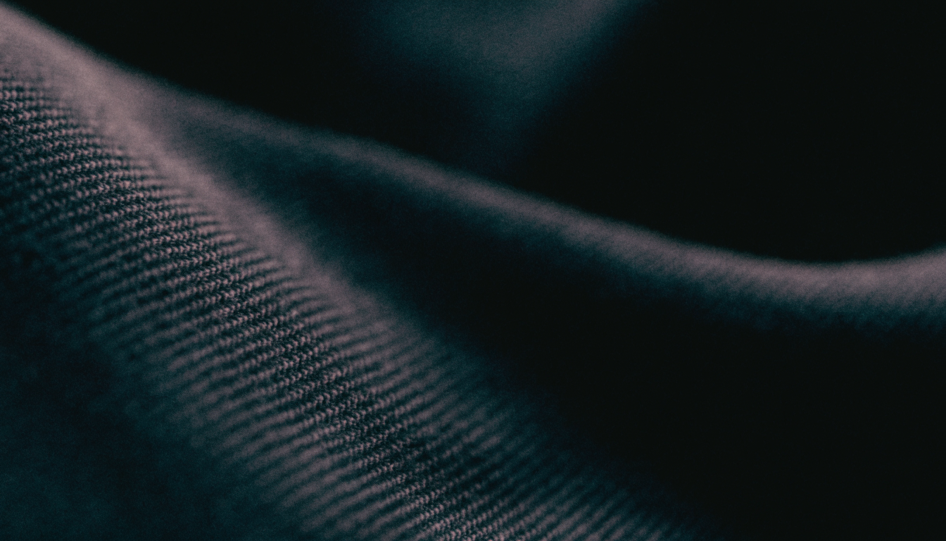 Extreme macro of silk weave, the edge of a fold catching low natural light